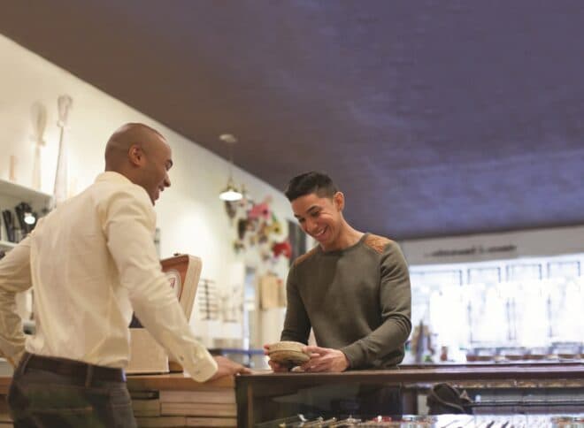 Vendor interacting with customer at local business